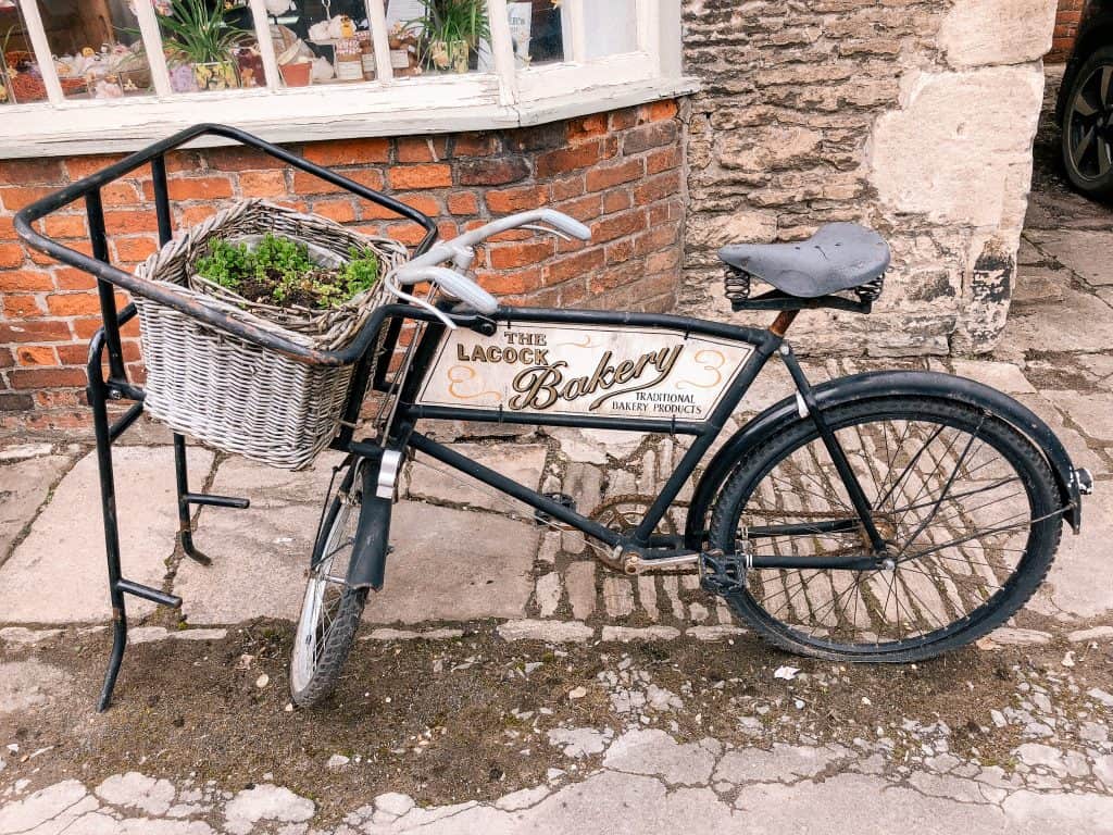 Lacock Bakery, Bike Planter, Lacock, Wiltshire, Cotswolds, UK, National Trust, England, English Countryside
