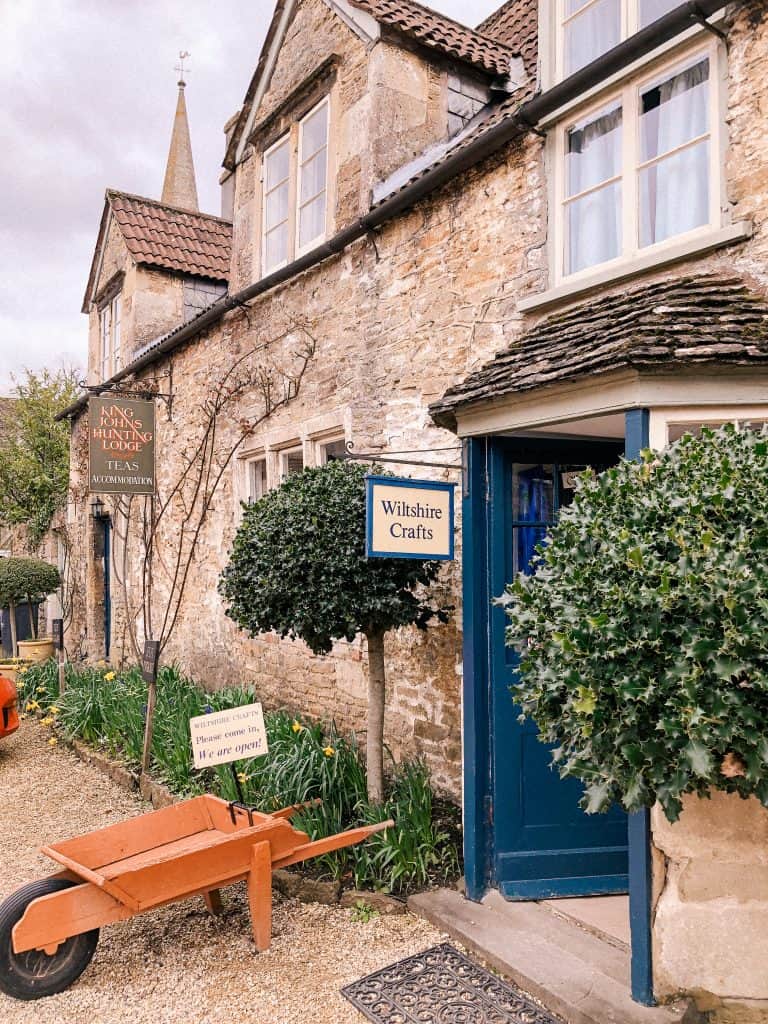 Lacock, Wiltshire, Cotswolds, UK, National Trust, England, English Countryside, blue doors, orange wheelbarrow, daffodils, spring, easter