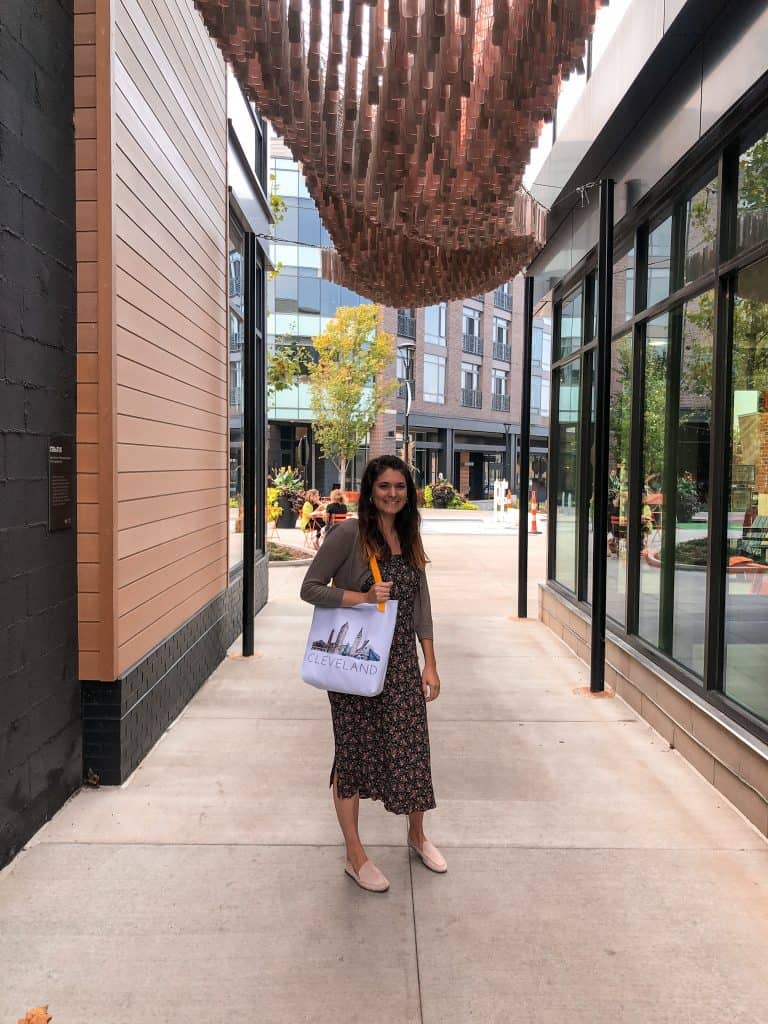 Woman with Cleveland tote bag at the Art installation at Van Aken District